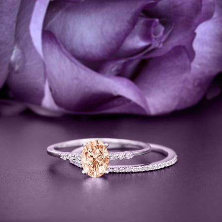 a close up of a ring on a table with a flower in front of it