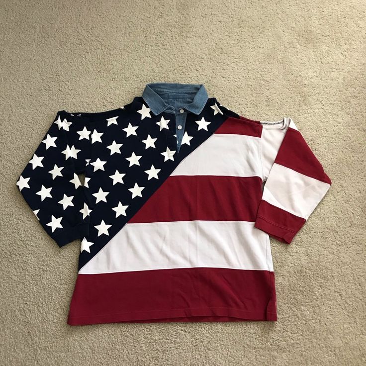 two polo shirts with the american flag on them, one blue and one red are laying on the floor