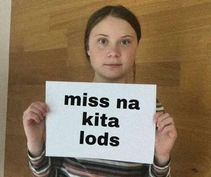 a woman holding up a sign that says miss na kita lods on it