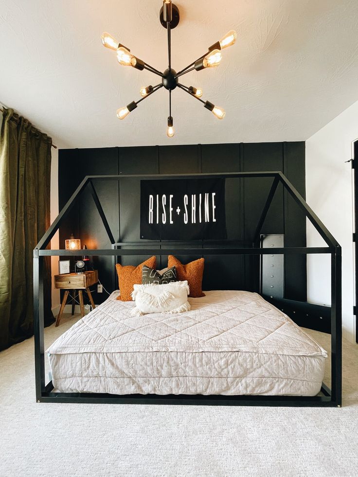 a black and white bedroom with a bed frame that says rise - shine on the wall