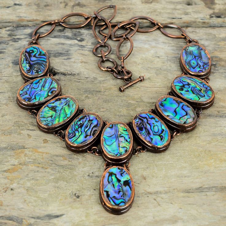 Note : Due to the natural formation of this gemstone. Slight variation in design and color are to be expected.  Abalone Shell Necklace Electroformed Copper Adjustable Chain Necklace Handmade Necklace Real Gemstone Necklace Copper Jewelry Gifts For Her Handmade Electroformed Copper Necklace SKU : VZN-54 Gemstone : Abalone Shell Stone Shape : Oval Metal Purity : Copper Necklace Length : 16 Inches To 18 Inches With Adjustable Chain Abalone Shell is said to enhance feelings of peace, compassion and Oval Natural Stone Necklace, Nature-inspired, Nature-inspired Oval Necklaces With Natural Stones, Artisan Necklace With Large Round Stone, Unique Oval Stone Necklaces, Artisan Necklace With Large Stone In Oval Pendant, Silver Oval Electroformed Necklace, Artisan Oval Pendant Gemstone Necklace, Oval Cabochon Necklace With Nature-inspired Style, Artisan Multicolor Cabochon Necklace