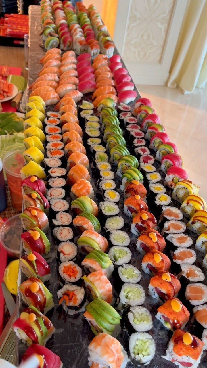 many different types of sushi are lined up on a table