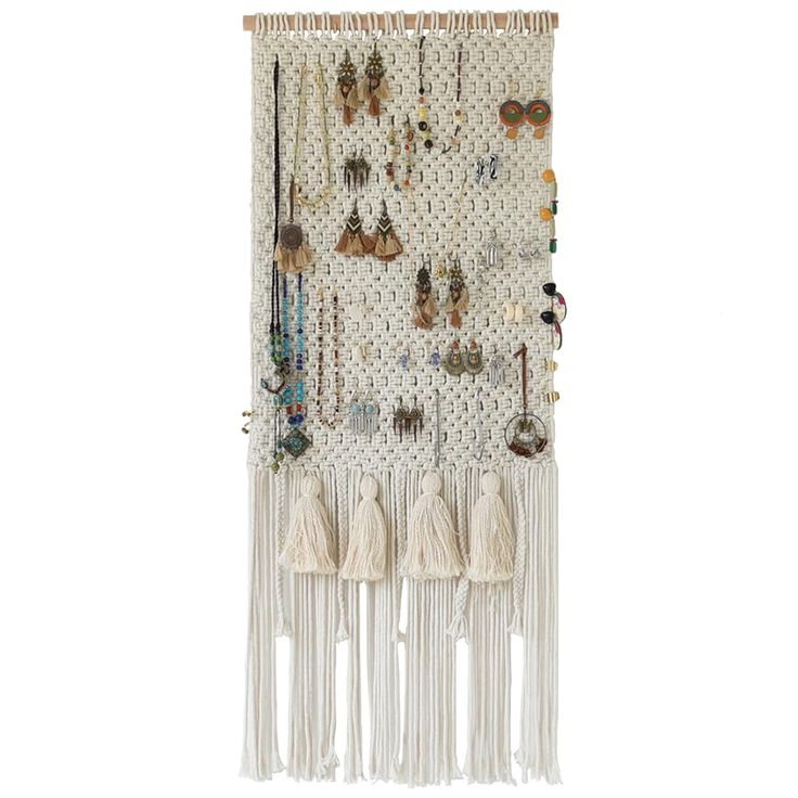 a white wall hanging with earrings on it