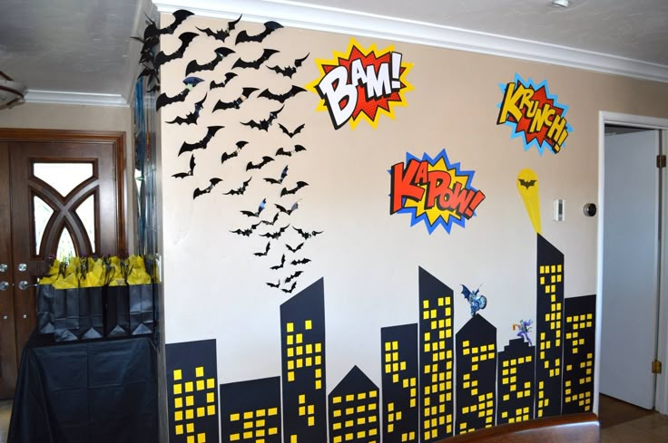 a room decorated with batman themed wallpaper