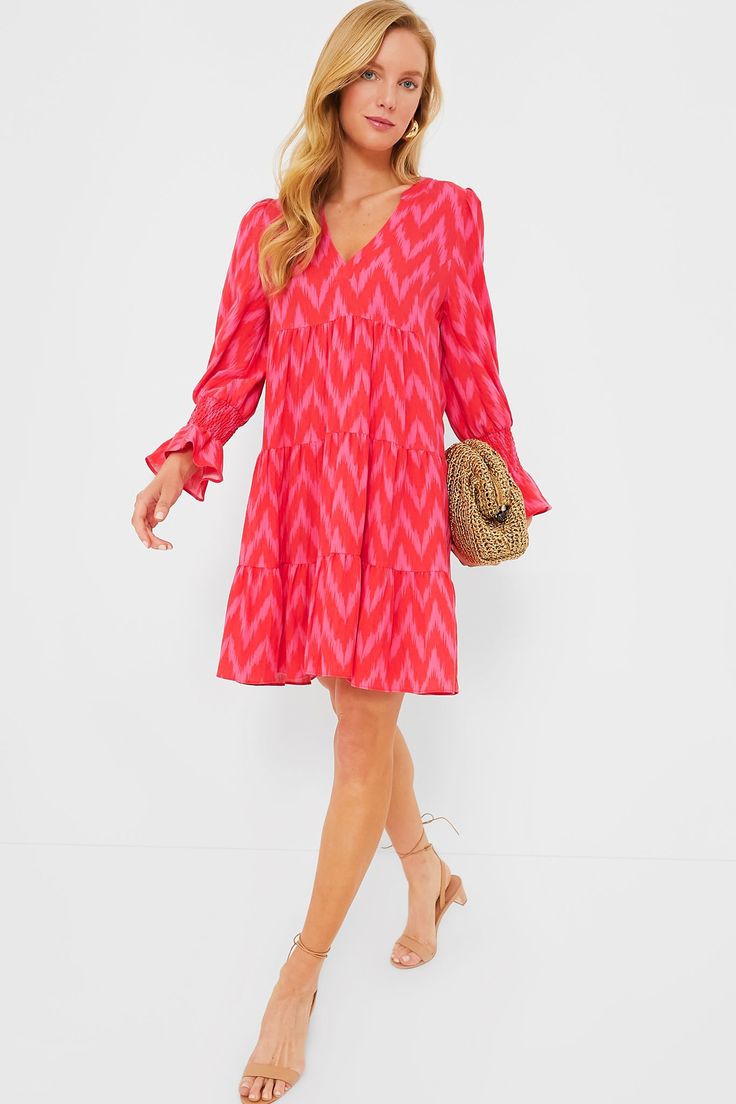 A Tuckernuck fan favorite, the Hot Pink Ikat Kenzo Dress is the mini of the season. Featuring feminine flutter smocked cuffs, a V-neckline and a loose empire waist, this is the most flattering flirty frock! Pair with flats for a casual look or dress up with heels and statement earrings for date night. V-neckline Long sleeves Elasticated ruffle cuff Swing shape Tiered skirt Mini length Material: 75% Rayon, 25% Nylon Care: Hand wash cold Kenzo Dress, Plus And Minus, Skirt Mini, Tier Skirt, Tiered Skirt, Empire Waist, Statement Earrings, Smocking, Date Night