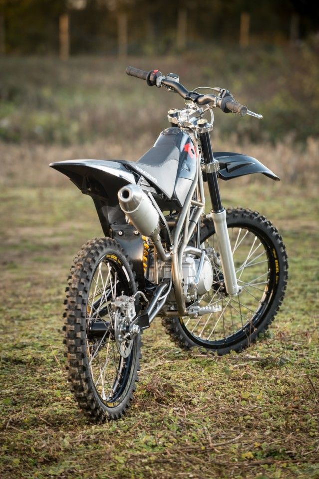 a dirt bike parked on top of a grass covered field