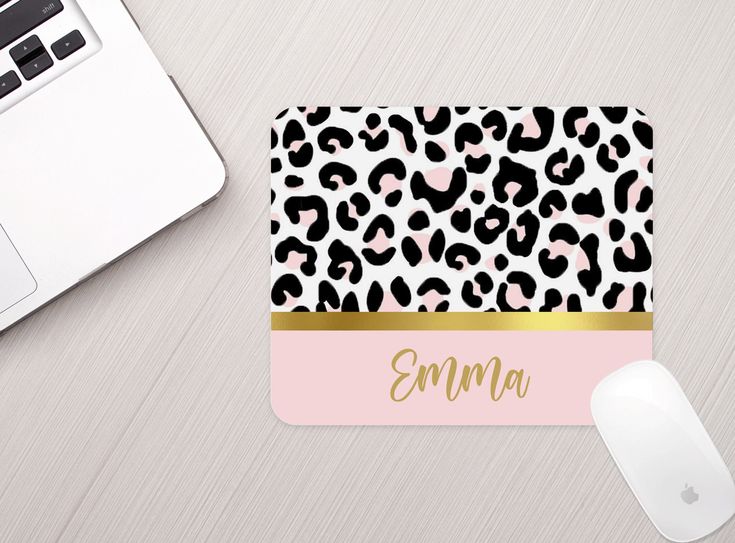 personalized mouse pad with leopard print and gold name on pink background next to computer keyboard