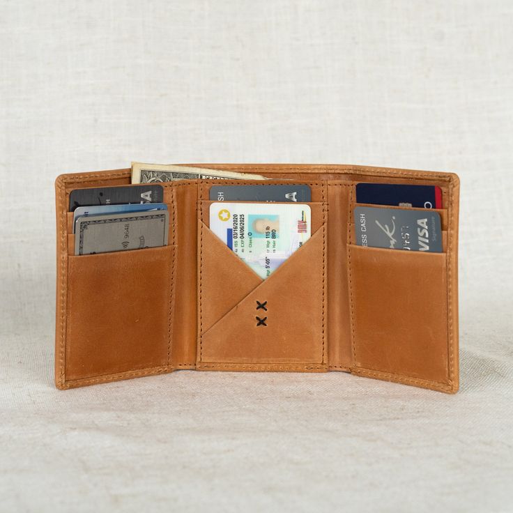 The Titus… the men’s trifold wallet you’ve been asking for! Crafted with durable, full-grain leather, this wallet boasts a classic design that's built to last. Over time, it develops a beautiful patina finish, adding character to its timeless style. With eight card slots and a designated cash spot, it offers both style and functionality. Handcrafted by artisans in India, it's a timeless accessory he'll cherish for years to come. 3.5" wide, 4" tall 8 card slots 1 spot for cash Full-grain leather Leather Trifold Wallet With Waxed Finish, Brown Trifold Wallet With Rfid Blocking For Everyday Carry, Classic Trifold Wallets For Everyday Use, Classic Trifold Wallet With Waxed Finish, Brown Trifold Wallet With Smooth Grain, Classic Trifold Wallet For Everyday Carry, Leather Trifold Wallet With Coin Pocket For Everyday, Classic Leather Trifold Wallet With Coin Pocket, Classic Leather Trifold Wallet With Coin Pocket For Everyday