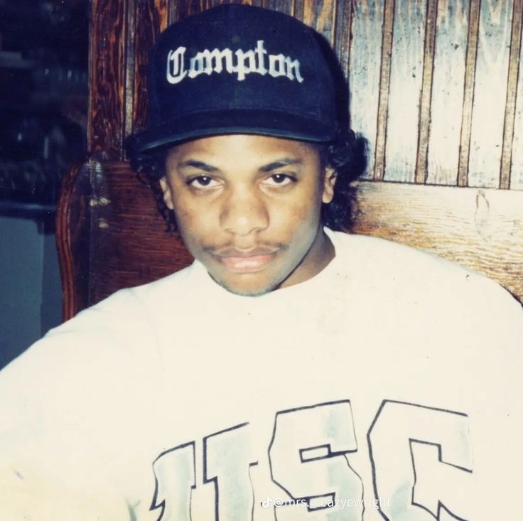 a young man wearing a white shirt and black hat with the word champion on it