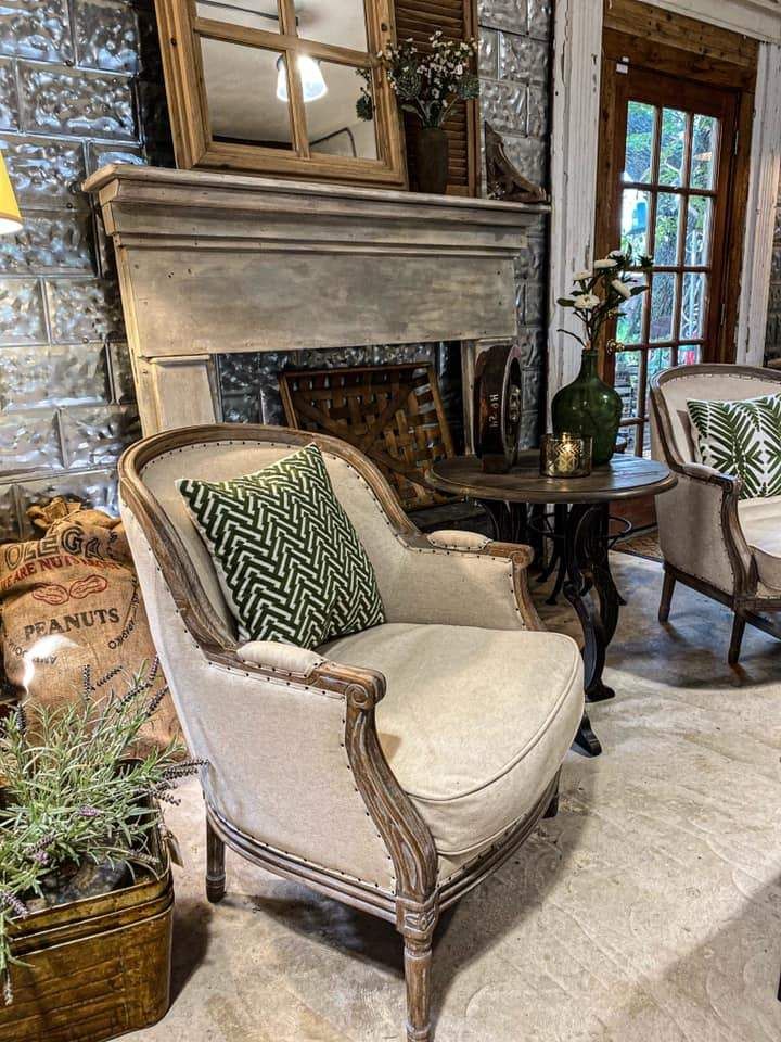 a living room filled with furniture and a fire place in front of a stone fireplace