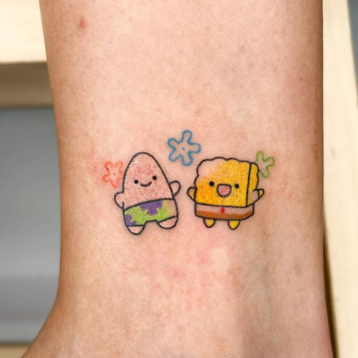 two cartoon tattoos on the side of a woman's leg