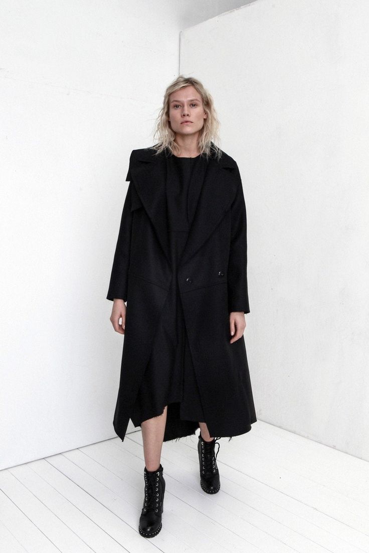 "Premium quality Black woolen coat has an oversize silhouette through the body , crafted in a heavy and thick high quality Italian wool fabric. Calf-length coat is fastened with two knobs. The coat has a unique cut , features big collar, long sleeves and is very stylish. This coat has a horizontal line through the front and back, there are large pockets in front. On one side on the shoulder is a decorative detail. The coat is with viscose lined. This coat is very stylish and unique created by a Black Wool Coat With Lapel Collar For Fall, Chic Black Wool Coat For Winter, Black Long Pea Coat With Pockets, Black Oversized Long Outerwear, Oversized Long Black Outerwear, Chic Black Wool Coat, Black Long Oversized Outerwear, Chic Black Long Sleeve Wool Coat, Chic Long Black Outerwear