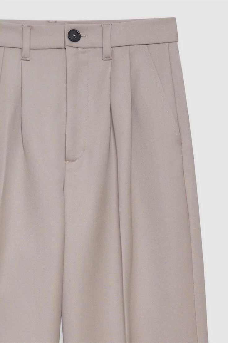 Designed by Anine Bing. The Carrie Pant in white linen blend is a wide-leg trouser made from a light and breathable linen blend. This full-length style features double-pleated front detailing, five functional belt loops, two faux back welt pockets, slanted front pockets, and a single button zip-front closure. Fully lined. Fit: The Carrie Pant is cut for a high-rise fit, relaxing through the thigh into a wide-leg hem. Take your true size. Model is wearing a size 32. Model Measurements: Height: 5' Neutral Wide-leg Pants With Belt Loops, Formal Beige Wide Leg Pants With Belt Loops, Classic Neutral Pants With Belt Loops, Elegant Neutral Pants With Belt Loops, Elegant Neutral Bottoms With Belt Loops, Classic Beige Wide Leg Pants With Belt Loops, Classic Wide Leg Pants With Straight Hem For Summer, Classic Neutral Bottoms With Belt Loops, Classic Wide Leg Box Pleat Bottoms