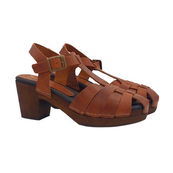 Women's sandals with leather upper & Brown wood effect baseEntirely made by specialized Italian personnelHandcrafted using the best materialsHeel height 7 cm with 2 cm platformComfortable padded insoleadjustable ankle strap, very comfortable and stylish.Designed & Produced By"MY Clogs" Leather Closed Toe T-strap Sandals With Platform, Leather Platform T-strap Sandals With Closed Toe, Leather T-strap Sandals With Platform And Closed Toe, Brown Open Toe T-strap Sandals With Removable Insole, Brown Platform Slingback Sandals With Closed Toe, Brown Closed Toe Slingback Sandals With Buckle, Brown T-strap Sandals With Heel Strap And Open Toe, Brown Platform Sandals With Round Toe, Brown Wedge Sandals With Leather Sole