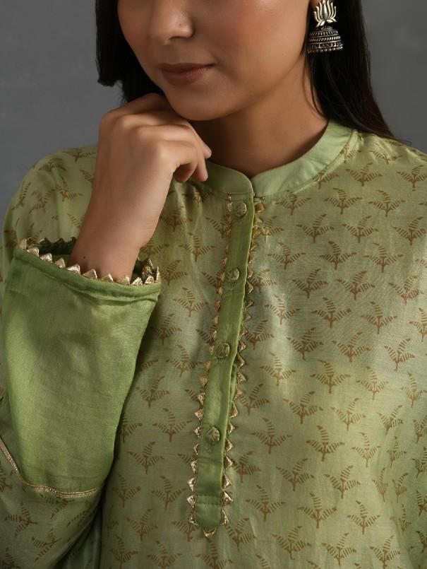 A free-size flowy green chanderi kurta with gold block print, gota detail and pleated hem. Garment Measurements (in Inches): Free size: Length - 47", Bust - 61", Waist - 60" Fabric: Chanderi (Cotton silk) Color: Green Fit: Model height - 5"7" Fit - Loose/comfortable Technique: Hand block printed in gold with gotta details Instructions: Dry clean only Note: Available in other colors This product will be shipped within 20-25 days of the order placed Green Fits, Best Deal, Cotton Silk, Model Height, Block Print, Free Size, Hand Weaving, Dry Clean, Saree