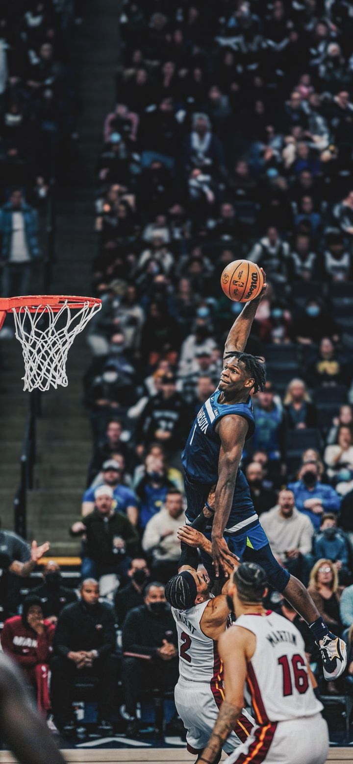 the basketball player is jumping up to dunk the ball