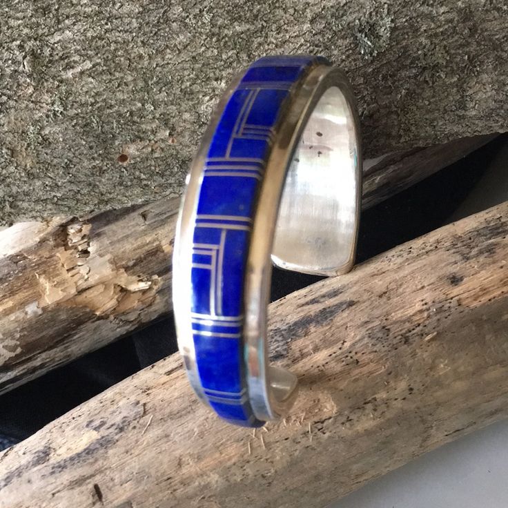 Amazing Bracelet For A Lapis Lover! Gorgeous Lapis Channel Inlay Work Handcrafted By Navajo Native American Wilbur Yazzie. Solid Well Made Bracelet Weighs 66.65 Grams. The Width Is 3/4” At The Widest Narrowing Down To 3/8” The Inner Circumference Of The Bracelet Is 6 3/4” Which Includes The Cuff Measurement Of 5 1/2” Plus A Gap Of 1 1/4” To Total The Size Of 6 3/4” Stamped Sterling Hallmark Wil. Wilbur Yazzie New Condition Never Worn From Vintage 80’s Collection B358 American Indian Tribal Handmade Bohemian Blue Sterling Silver Bracelet, Southwestern Style Blue Bangle Bracelets, Southwestern Style Blue Bangle Bracelet, Handmade Adjustable Blue Sterling Silver Bracelet, Classic Blue Sterling Silver Bracelet, Adjustable Blue Engraved Cuff Bracelet, Elegant Blue Cuff Bracelet With Polished Finish, Formal Blue Inlay Jewelry, Southwestern Blue Cuff Bracelet As Gift