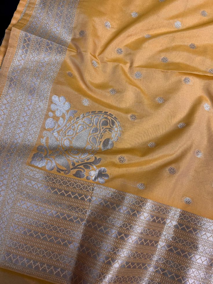 Beautiful Mango Yellow Color Handmade Dupatta with Koniya design and small buttis all over the dupatta, Muted Gold Zari Weaving. Super Light weight and very easy to carry. Can be worn with a Suit or lehenga easily. Please note- : The Color will give a shade of Dark Mango Yellow color in Roomlight and lighter shade of Mango Yellow in Sunlight. Item: DupattaBase color : Mango YellowZari Work : Muted Gold Fabric : Premium quality Banarasi Soft SilkWork : Zari Weaved with tasselsLength of the dupatt Traditional Gold Pre-draped Saree With Motifs, Gold Chanderi Choli With Motifs, Gold Sets With Zari Weaving For Navratri, Elegant Yellow Sets With Zari Weaving, Gold Handloom Dola Silk Blouse Piece, Gold Banarasi Silk Sets With Cutdana, Gold Banarasi Silk Set With Cutdana Details, Traditional Yellow Pre-draped Saree With Self Design, Gold Chanderi Sets With Motifs