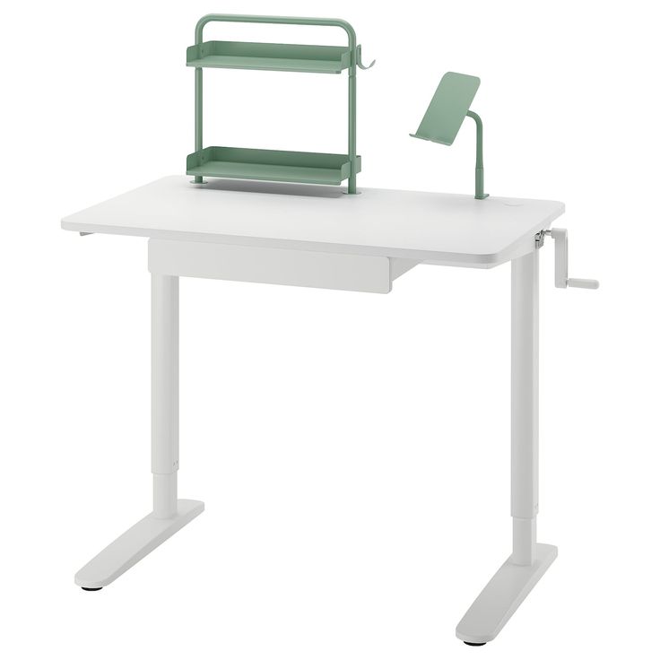 a white desk with a green chair sitting on it's top and the seat up