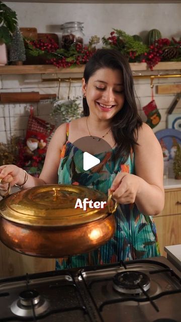 a woman standing in front of an oven holding a pot