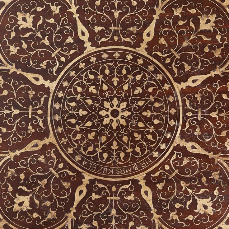 an intricately designed wooden table top