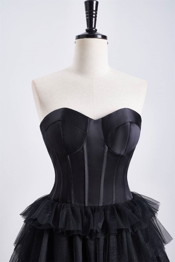 This dress features a corset bodice and a tiered ruffle skirt, with a sweetheart neck and zip-up back. Made from black tulle, it has an A-line silhouette and falls above the knee. Item #NP1112 Material: Tulle Color: Black Silhouette: A-line Embellishment: Corset bodice, tiered ruffle skirt Neck: Sweetheart neck Back: Zip-up Length: Above knee length Fully lined: Yes Built-in bra: Yes True to size. Made in China. Dresses are usually packed inside out for protection. Hand wash Tulle Corset Dress With Corset Back For Night Out, Black Corset Dress With Sweetheart Neckline For Prom, Tulle Corset Dress For Night Out, Black Corset Dress With Ruched Bodice For Prom, Night Out Tulle Corset Dress With Fitted Bodice, Black Boned Bodice For Evening Wear, Black Boned Bodice For Evening, Formal Corset Dress With Sweetheart Neckline And Ruffles, Ruffled Fitted Bodice Corset For Costume Party