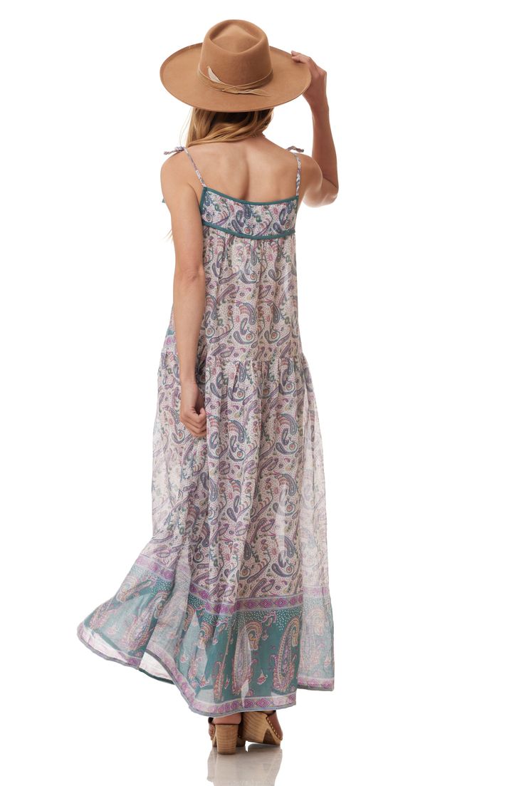 The Betsy long dress is perfect for summer. This dress is designed to be light and flowy. With a beautiful print, this dress is THE must-have item in your wardrobe this season.Color: Teal Size One Size, Fits Size 2 to 10 100% Indian Cotton Made in India Flowy Long Sundress For Beach Cover-up, Patterned Floral Print Maxi Boho Dress, Patterned Summer Dresses For Vacation, Patterned Midi Dress For Summer Vacation, Patterned Summer Dress For Vacation, Summer Vacation Dresses In Patterned Color, Patterned Summer Vacation Dresses, Bohemian Patterned Maxi Dress With Boho Print, Patterned Bohemian Dress