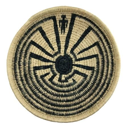 a black and white basket with an intricate design in the center, on a white background