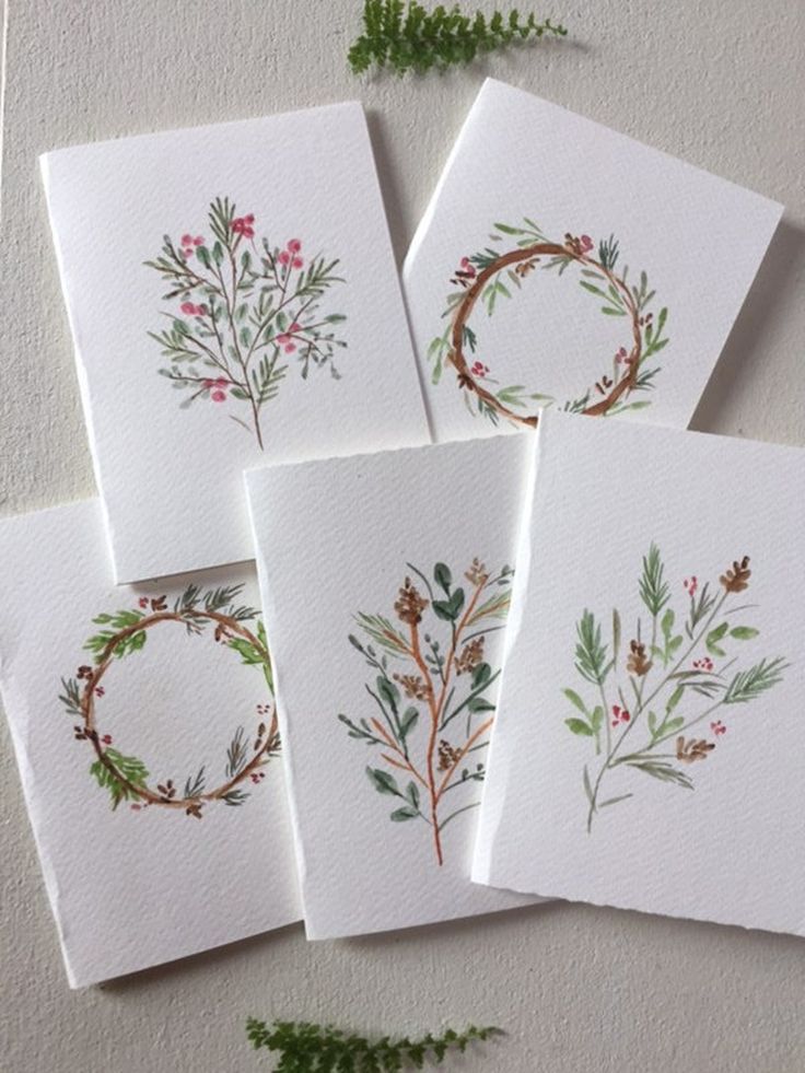 four cards with watercolor flowers on them and greenery in the middle one is blank