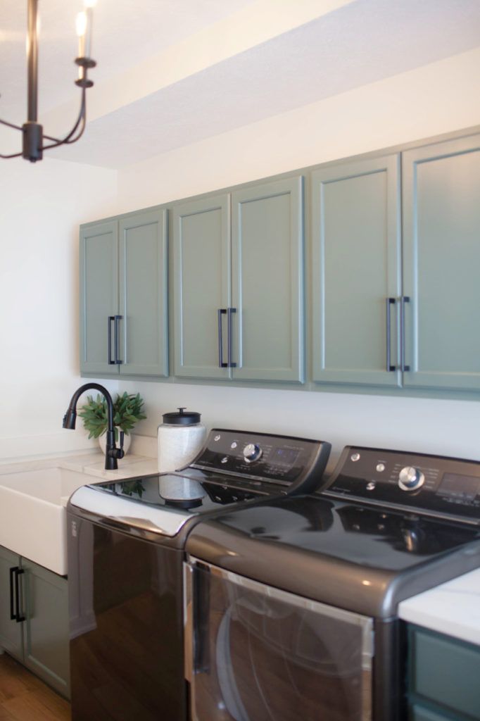 a washer and dryer sitting in a kitchen next to a counter with cabinets