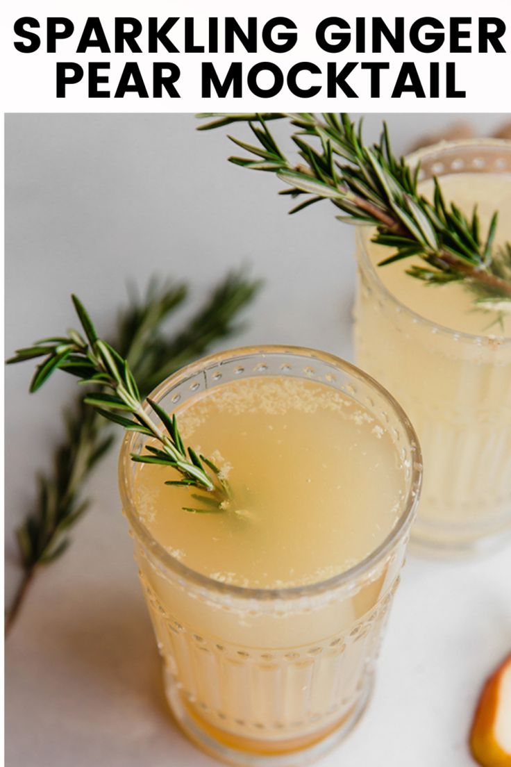 two glasses of sparkling ginger pear cocktail with rosemary garnish on the rims