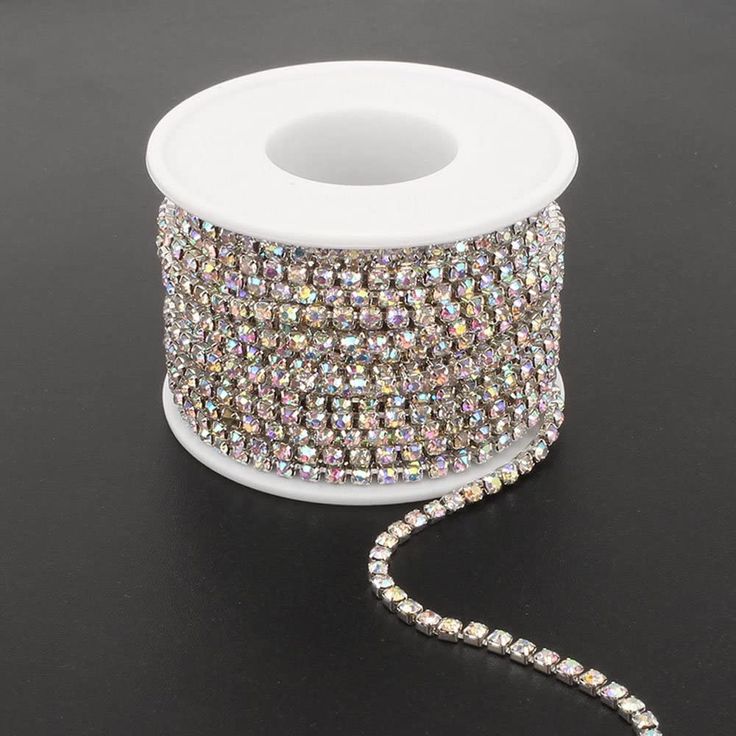 a spool of crystal beaded ribbon on a black surface