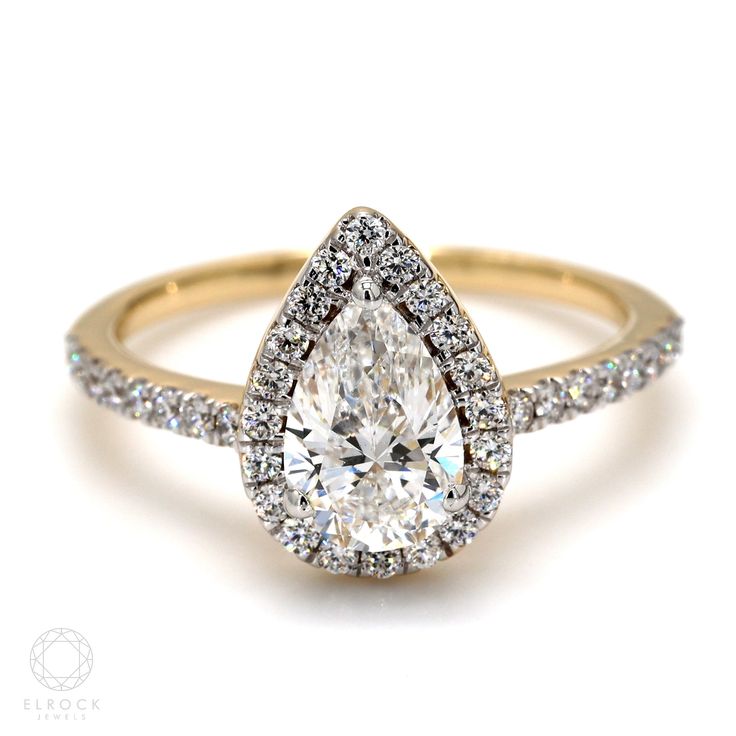 a pear shaped diamond engagement ring set in yellow gold