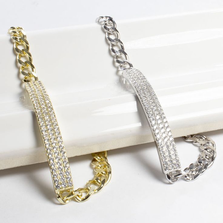 Always on the look-out for the latest fashion trend? This gorgeous rectangle bar bracelet twinkles with cubic zirconia stones. The nice link chain has a lobster clasp and makes this the perfect accessory for any occasion. This bracelet will be the perfect gift for that special someone in your life. - Stones Material: Cubic Zirconia.- Stones Shape: Round.- Metal: 925 Sterling Silver.- Plating: Gold and Rhodium plated.- Length: 7" (17.8 cm) and 1.8 cm adjustable.- Size of Charm: 5 mm wide x 4 cm l Party Bracelets With Rectangular Links, Rectangular Cubic Zirconia Bracelets, Rectangular Jubilee Bracelet In Cubic Zirconia, Trendy Silver Cubic Zirconia Chain Bracelet, Silver Cubic Zirconia Diamond Bracelet Rectangular Shape, Rectangular Silver Diamond Bracelet With Cubic Zirconia, Silver Cubic Zirconia Bracelet With Rectangular Links, Rectangular Silver Bracelet With Diamond Accents, Rectangular Diamond Bracelet With Diamond Accents As A Gift