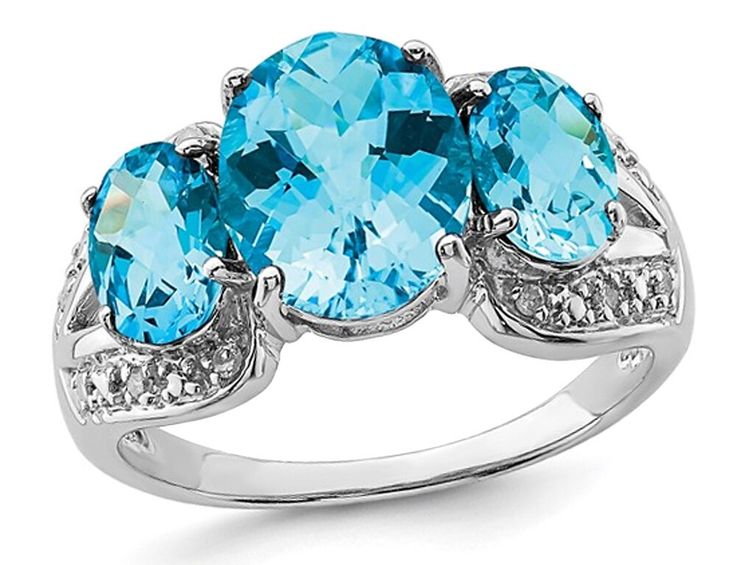 5.40 Carat (ctw) Blue Topaz Three Stone Ring in Sterling SilverAn Oval cut shaped swiss blue topaz gemstone is supported by two additional oval-cut blue topaz gemstones, in the embrace of crisp rhodium plated sterling silver in this attractive gemstone ring featuring the birthstone of December.Beautifully Crafted in 0.925 Sterling Silver with a Polished FinishStone Type: Blue Topaz; Color: Blue; 5.40 CTW; Quantity: 3; checkerboard-cut Cut; Oval Shape; Dimensions: 10 mm; Natural; Prong SettingThi Topaz Diamond Ring, 12 December, Three Stone Ring, Blue Topaz Stone, The Embrace, Sterling Silver Rings Bands, Sky Blue Topaz, Swiss Blue Topaz, Topaz Stone