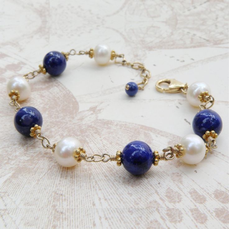 Elegant lapis lazuli and white pearl bracelet is handcrafted with gorgeous natural lapis lazuli gemstones and beautifully polished freshwater pearls. These gemstones and pearls are all natural which makes them even more precious. A thoughtful gift for a woman born in September since lapis lazuli is one of the birthstones for September. Alternatively, a gorgeous blue gift for a woman born in June since the pearl is her birthstone. An beautiful bracelet perfect for the blushing bride who loves uni Pearl Gemstone Bead Bracelet, Round Lapis Lazuli Bracelets With Polished Beads, Polished Beads Lapis Lazuli Round Bracelets, Polished Beads Lapis Lazuli Bracelets, Blue Pearl Jewelry With Polished Beads, Handmade Elegant Blue Pearl Bracelet, Elegant Handmade Blue Pearl Bracelet, Elegant Blue Round Pearl Bracelet, Elegant Blue Pearl Bracelet