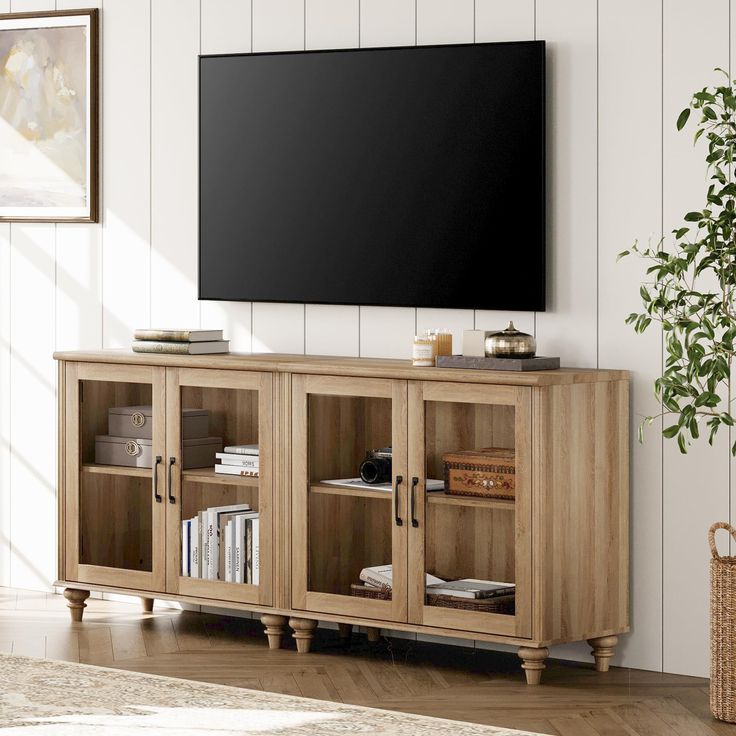 an entertainment center with a flat screen tv mounted on the wall