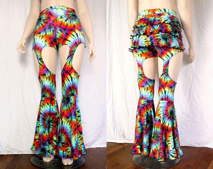 "These pants have everything: - high waist (rise measurement depends on size) - 3 layer ruffle butt - garter style legs - large circle flares - with more ruffles! Matching top coming soon! These are available in our select prints: Blue Galaxy, Fineapple, Neon Chevron (UV reactive), Rainbow Mermaid, Rainbow Tie Dye (shown - UV reactive), and Baelien. All are 4 way stretch spandex. These are currently available in standard sizing Small - 4X, standard inseam length 32\". See last photo for full siz Fitted Flares For Spring Festival, Fitted Hippie Flares For Summer, Hippie Flare Stretch Bottoms, Fitted Hippie Party Pants, Fitted Hippie Pants For Party, Groovy Pants For Spring Festival, Groovy Festival Pants For Spring, Fitted Hippie Style Pants For Party, Stretch Festival Bottoms With Ruffles