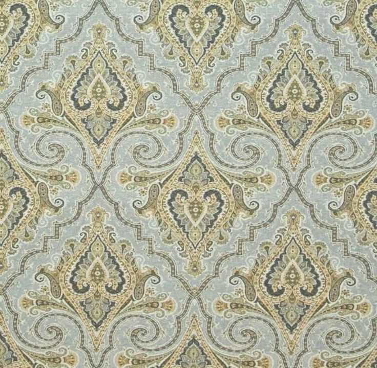 a blue and yellow wallpaper with an ornate design on it's surface,