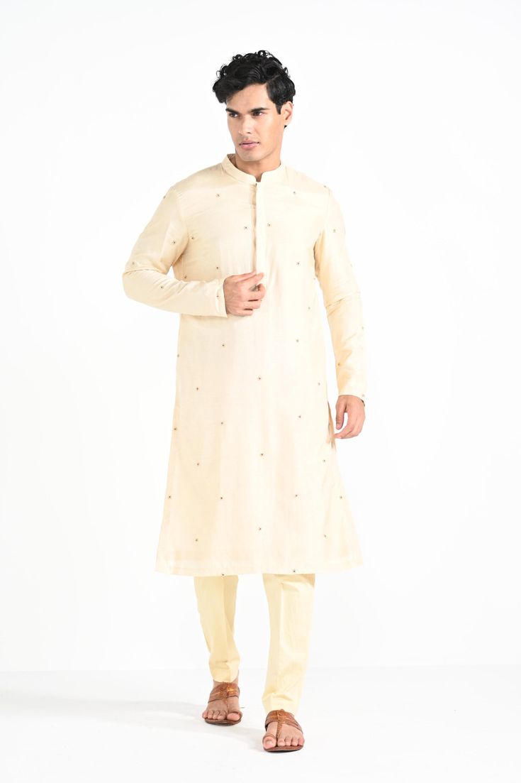 Rajasthani floral Hand embroidered nehru kurta set made in cream bamberg raw silk. Paired with cream slim fit Pant Pajama. Color of the actual garment may vary due to lighting conditions during the shoot.

Size Chart For Men





	
	
					Men's Size Chart
		

		
		
						
				Size Chart For Men
				Custom Size Measurement Guide
			
			
				
				
				Custom Size Measurement Guide
1. Take your measurements at ease…don’t hold your breath!
2. Be a little generous with the measurements. It’s always e Off-white Churidar With Straight Kurta, Off White Kurta With Gota Work For Eid, Festive Cream Cotton Silk Traditional Wear, Designer Straight Kurta In Off White, Off White Chanderi Kurta For Diwali, Festive Off White Straight Kurta, Festive Cream Cotton Silk Churidar, Cream Cotton Silk Kurta With Zari Work, Transitional Chanderi Kurta In Off White