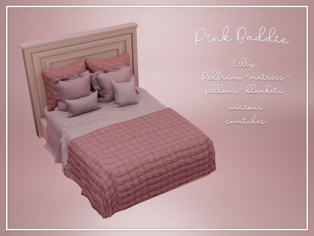 a pink bed with pillows and blankets on it