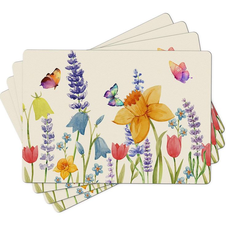 four coasters with colorful flowers and butterflies on them, one has a white background