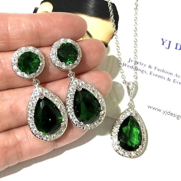 "A classic emerald green bridal jewelry set featuring teardrop cz earrings and pear drop necklace pendant made of cubic zirconia teardrops and brilliant cz, hanging onto white gold silver rhodium plated posts, bail and chain. Earrings measure about 1 3/8\" (3.5cm) long including posts. Pendant is 1 1/4\" (3.1cm). Chain length can be added with a 2\" extender chain. View matching, similar design and other color options at https://etsy.me/2XN9lO3 * Pics on mannequin in clear cz silver base is for Green Cubic Zirconia Teardrop Pendant Jewelry, Wedding Emerald Teardrop Pendant Jewelry, Emerald Teardrop Pendant For Wedding, Wedding Teardrop Emerald Pendant Jewelry, Green Crystal Bridal Earrings For Wedding, Green Drop Jewelry For Wedding, Green Teardrop Earrings For Wedding, Emerald Drop Jewelry For Weddings, Green Teardrop Dangle Earrings For Wedding