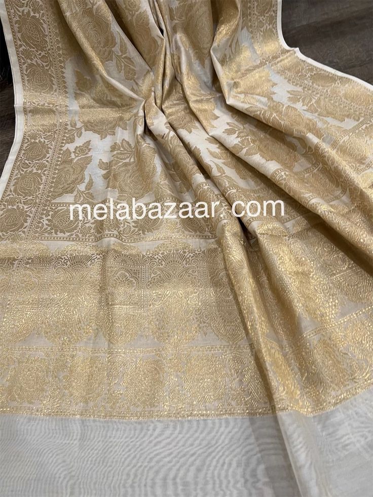 Gorgeous cotton silk white Banarsi dupatta with beautiful rose motifs in gold zari. Luxury Resham Embroidery Banarasi Silk Dupatta, Luxury Silk Thread Elegant Dupatta, Luxury Tissue Silk Dupatta With Pallu, Luxury Banarasi Silk Dupatta With Pallu, Affordable Gold Dupatta With Zari Work, Luxury Formal Katan Silk Dupatta, Luxury Fitted Dola Silk Dupatta, Gold Cotton Silk Traditional Wear For Eid, Elegant Gold Banarasi Silk Dupatta