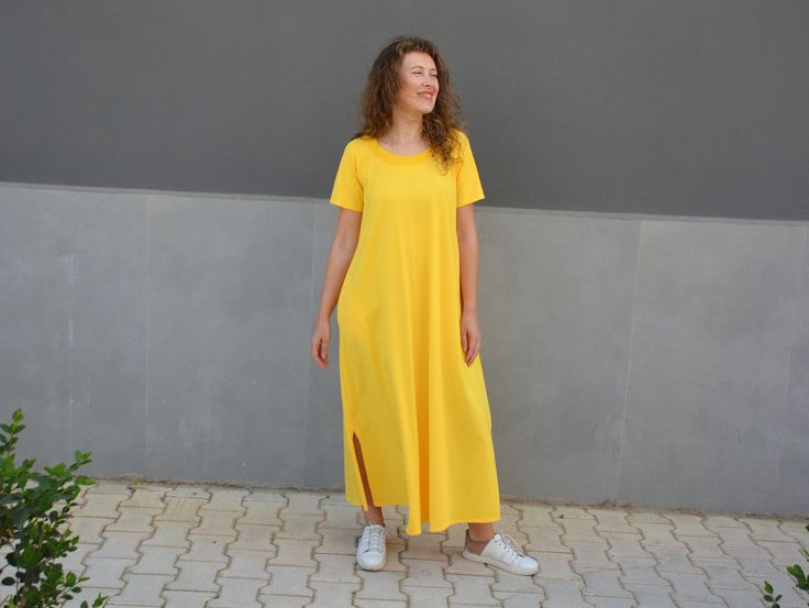 Embrace the carefree spirit of summer with our chic Yellow Summer Dress with Pockets! This A-line t-shirt dress is crafted from 100% cotton for maximum comfort and breathability, making it the perfect choice for those long summer days. Whether you're strolling along the beach or enjoying a casual brunch with friends, this cotton maxi dress will keep you cool and stylish. The sunny yellow hue adds a pop of color to your wardrobe, while the practical pockets make it a functional and versatile piec Relaxed Fit Cotton A-line Maxi Dress, Casual Cotton T-shirt Dress With Relaxed Fit, Summer Cotton Maxi Dress With Pockets, Casual Cotton Summer Dresses, Spring Cotton Midi Dress With Side Slits, Casual Cotton Maxi Dress For Day Out, Casual Cotton Short Sleeve Dresses, Casual Short Sleeve Cotton Dresses, Short Sleeve Maxi Dress With Pockets For Day Out