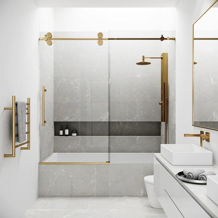 a white bathroom with gold accents and marble counter tops, along with a walk in shower