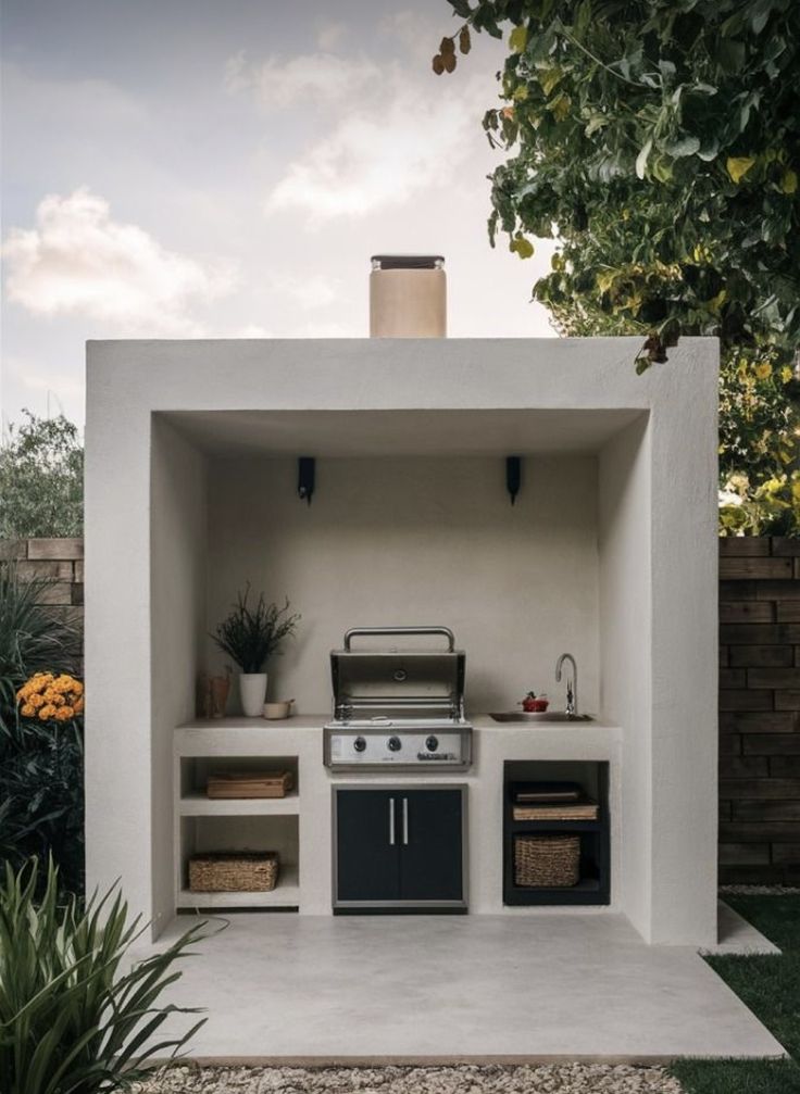 an outdoor kitchen is built into the side of a house