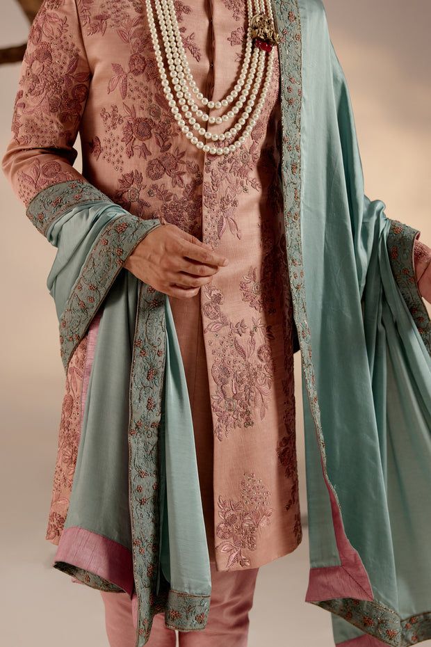 Orchid Pink Sherwani | Jatin Malik Introducing our stunning orchid pink sherwani, a true masterpiece of elegance and sophistication. This sherwani is adorned with intricate hand embroidery details, featuring shades of pink and zari that create a mesmerizing visual impact. Each stitch is meticulously crafted to enhance the richness of the design, making this ensemble a work of art. Perfect for those who appreciate refined craftsmanship and timeless style, this orchid pink sherwani is sure to make a statement at any special occasion or event. Included in purchase: Sherwani, Kurta, Churidar, Safa Product Specification Color: Dark pink Fabric: Linen silk Occasion: Engagement, Wedding, Bridal, Reception Style: Sherwani, Kurta, Churidar, Safa Care: Dry Clean Work: Hand Embroidery Customization o Pink Raw Silk Unstitched Suit With Traditional Drape, Pink Bandhgala With Resham Embroidery For Eid, Pink Fitted Bollywood Sherwani, Pink Churidar With Naqshi Straight Kurta, Pink Unstitched Suit With Naqshi For Wedding, Designer Pink Kurta With Naqshi Details, Pink Unstitched Churidar With Naqshi, Unstitched Pink Churidar With Naqshi, Pink Unstitched Naqshi Suit For Wedding