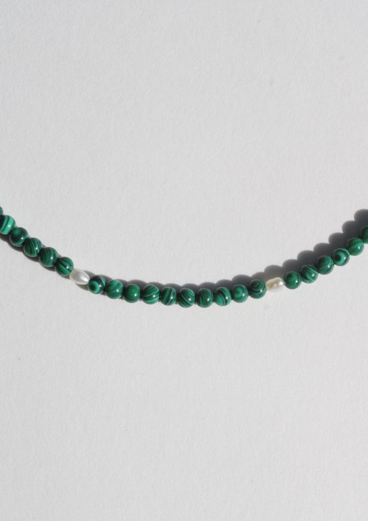 Another addition to our coveted strands of beads. A string of tiny malachite beads, seed pearls and finished with a 14 karat gold ball clasp. Measures 16" long Green Pearl Necklace With Gemstone Beads, Green Pearl Necklace With Round Gemstone Beads, Adjustable Beaded Malachite Necklace, Adjustable Beaded Malachite Necklaces, Beaded Malachite Necklaces, Spiritual Malachite Beaded Necklaces, Beaded Green Onyx Round Beads Necklace, Beaded Malachite Round Bead Necklaces, Green Single Strand Pearl Necklace With Round Beads