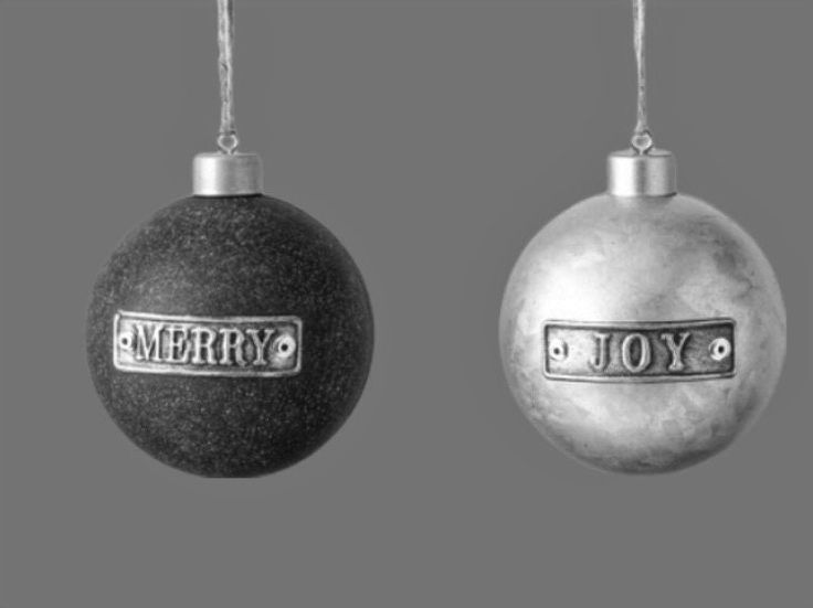 two ornaments with the word merry and joy hanging from chains on each ornament